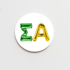 May include: A white circular sticker with the letters "ΣA" in green and gold balloon font.