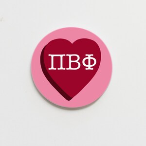 May include: A pink circle with a red heart in the center. The heart has the letters "ПВФ" in white.