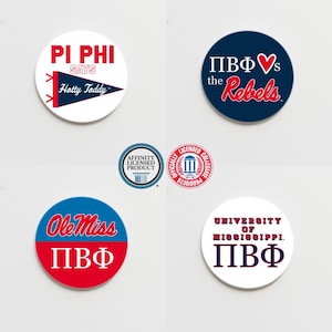 May include: Five round stickers with different designs related to the University of Mississippi. The stickers feature the school's colors of red and blue, and include the text "Ole Miss", "Pi Phi", "Pi Phi Says Hotty Toddy", "Pi Phi vs the Rebels", and "University of Mississippi Pi Phi".