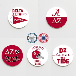 May include: Six round white coasters with red and black designs. The coasters feature the letters "AZ" and "Delta Zeta" with the phrase "Roll Tide" and a football helmet.
