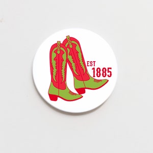 May include: White round sticker with two red and green cowboy boots and the text "EST 1885".