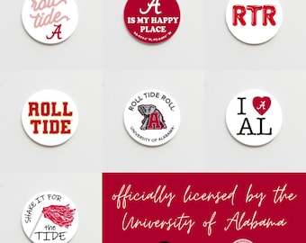 May include: A set of nine round, white buttons with red and white designs. The buttons feature various phrases and images related to the University of Alabama, including "Roll Tide", "A is my happy place", "RTR", "I love AL", and the university's mascot, an elephant. The buttons are officially licensed by the University of Alabama.