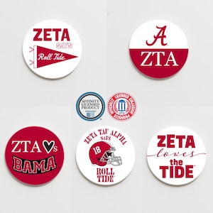 May include: Six round white and red stickers with various designs and text. The stickers feature the text "Zeta", "Roll Tide", "ZTA", "Bama", "Zeta Tau Alpha", "18", "Roll Tide", "Zeta", "loves", "the", "Tide".