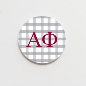 May include: A white and grey gingham coaster with the letters "AΦ" in burgundy.