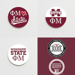 May include: Four round stickers with a maroon and white color scheme. The stickers feature the text "ΦΜ" and "State" in white lettering. One sticker has a heart symbol between the letters. Another sticker has a building with columns and a flag on top. The last sticker has the text "Officially Licensed Greek Product" around the building.