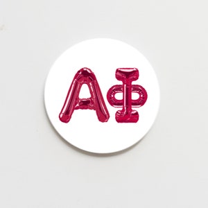 May include: A white round sticker with the letters A+ in red balloon letters.
