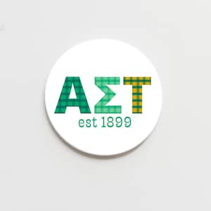 May include: A white circle with the letters AΣT in green and yellow plaid, with the text "est 1899" below.