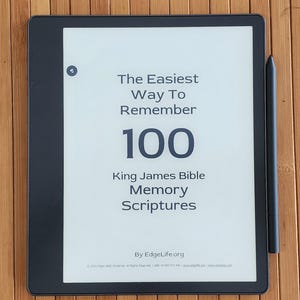 May include: A black and white e-reader with a white screen displaying the text "The Easiest Way To Remember 100 King James Bible Memory Scriptures" and "By EdgeLife.org".