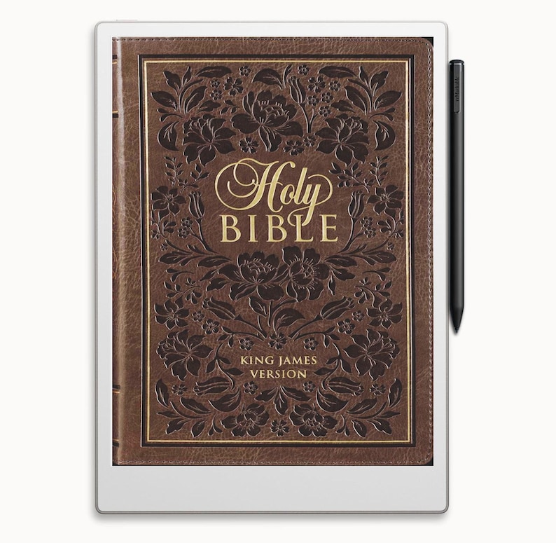 May include: A white e-reader with a brown leather cover displaying a digital version of the Holy Bible, King James Version. The cover features an embossed floral design and gold lettering.