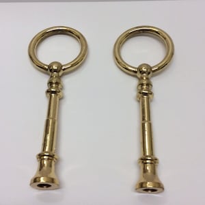 May include: Two gold metal cake plate stand supports with a round ring handle and a threaded base.