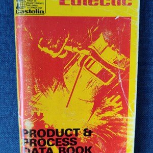 May include: A vintage book with a yellow and red cover. The title "Eutectic" is at the top, with "Product & Process Data Book" at the bottom. The cover features a welding illustration and the Castolin logo.