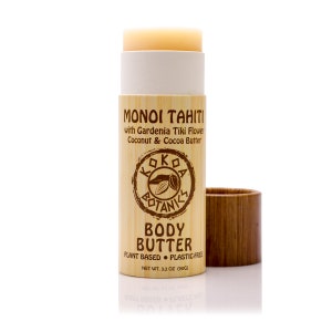 May include: A wooden tube containing a white and beige body butter stick. The tube is labeled "Monoi Tahiti with Gardenia Tiki Flower Coconut & Cocoa Butter" and "Kokoa Botanics Body Butter Plant Based Plastic-Free Net Wt. 3.2 oz (90g)".