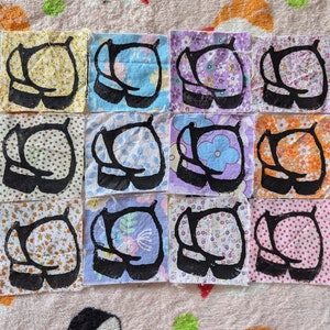 May include: Twelve fabric squares with a black silhouette of a pair of shoes on each. The squares are arranged in four rows of three. Each square has a different floral pattern in various colors, including yellow, blue, purple, orange, and pink.