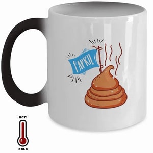 May include: White ceramic mug with a black handle. The mug has a color-changing design that reveals a brown cartoon pile of poop with a blue flag that says "1st April" when hot.