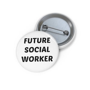 May include: Two white round buttons with the text "FUTURE SOCIAL WORKER" in black. One button is in the foreground, and the other is partially visible in the background. The buttons have a metal pin on the back.