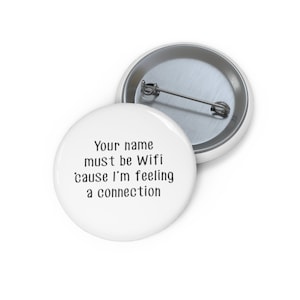 May include: White button with the text "Your name must be Wifi 'cause I'm feeling a connection" printed in black.