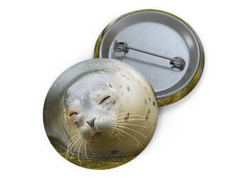May include: A close-up of a seal's face with its eyes closed. The seal is in the water and its head is sticking out of the water. The seal is brown and white with black spots.