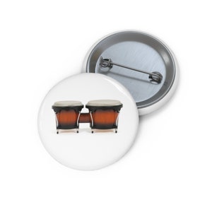 May include: A pair of brown wooden bongos with black rims and white heads. The bongos are set up in a traditional playing position.