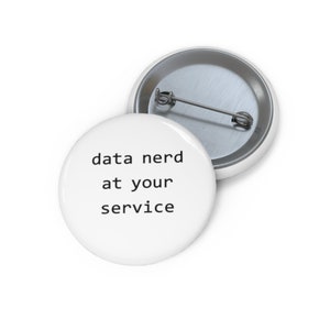 May include: White button with black text that reads "data nerd at your service".