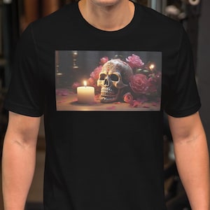 May include: Black t-shirt with a graphic print of a skull, a lit candle, and pink roses. The skull has decorative detailing. The image on the shirt has a dark, gothic theme.