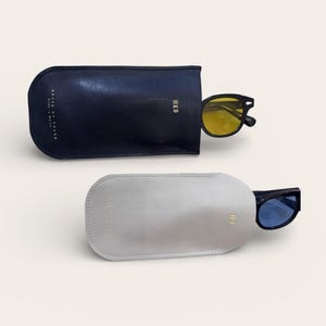 May include: A set of three ceramic mugs with a speckled, matte finish. The mugs are in shades of cream, light gray, and dark gray. Each mug has a simple, minimalist design, perfect for coffee or tea.