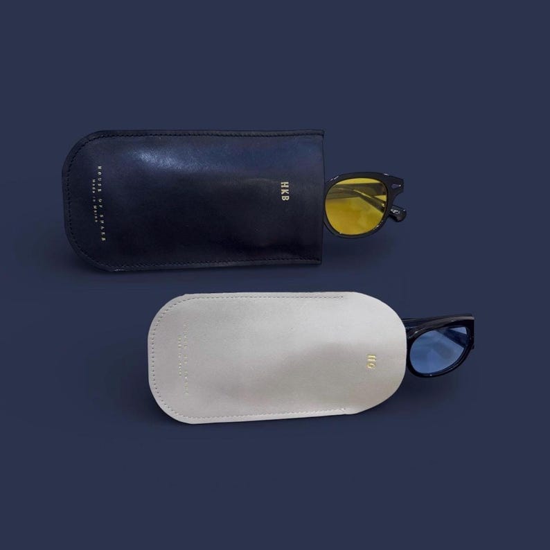 May include: A white ceramic mug with a black handle and the text "But First, Coffee" in a black, bold font. The mug is sitting on a wooden surface. The mug is approximately 4 inches tall.