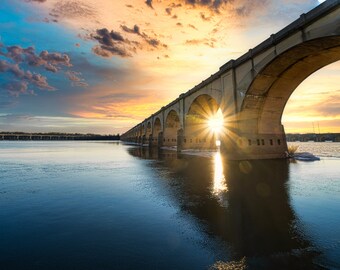 A beautiful sunset behind the train bridges going over the Susquehanna River into Harrisburg Pennsylvania. Print or Canvas
