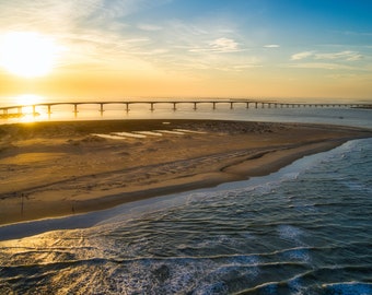 A sunset at the Outer Banks, NC.  It shows Bonner Pier (the old Bridge) and the new Marc Basnight Bridge at the Oregon Inlet.