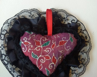 Handmade, hand-painted heart shaped scented sachet with red floral design and lace trim