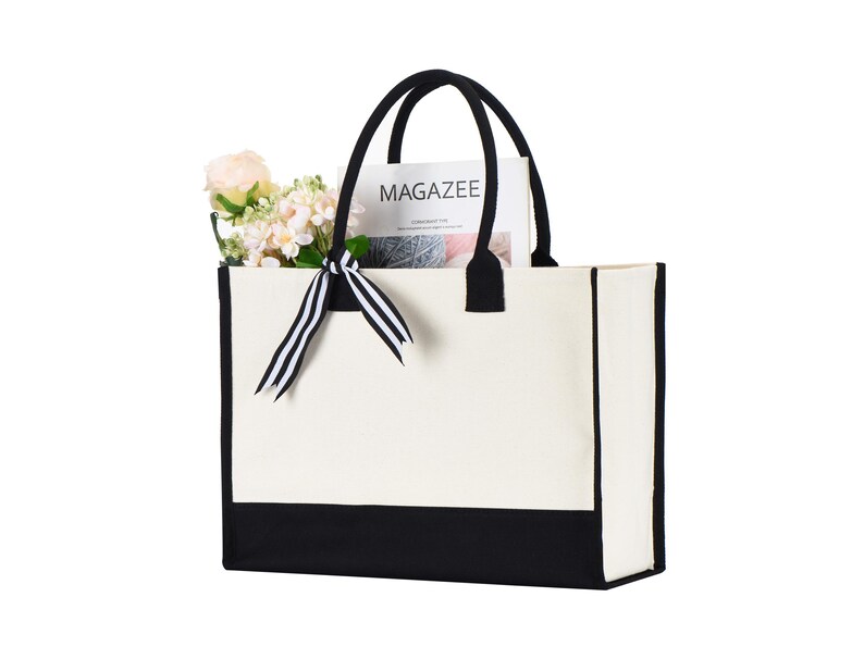 a black and white bag with a flower in it