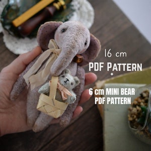 May include: A purple plush elephant teddy bear holding a small gray teddy bear in a woven basket. The elephant is 16 inches tall and the smaller bear is 6 inches tall.  The text "PDF PATTERN" and "6 cm MINI BEAR PDF PATTERN" is printed on the image.
