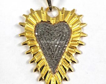 May include: A gold heart-shaped pendant with a diamond-encrusted surface. The pendant has a detailed design with a sunburst pattern around the heart.