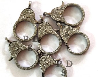 May include: Six silver-toned clasps with a diamond-like pattern. Each clasp has a round opening and a hook-like closure.