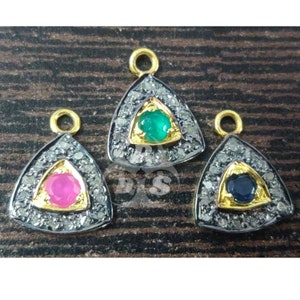 May include: Three gold triangle pendants with a single gemstone in the center of each. The gemstones are green, pink, and blue. Each pendant is surrounded by a halo of small white diamonds.