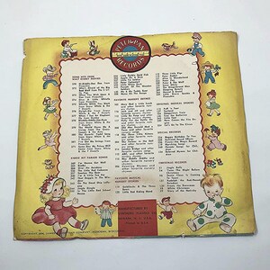 May include: A vintage record album cover featuring a colorful illustration of children playing music. The cover is yellow with a red border and features the text "Peter Pan Records with More Playing Time".