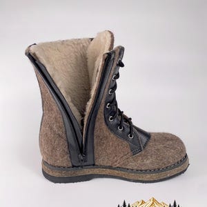May include: A mid-calf boot featuring a brown felted wool exterior, a black leather lace-up front with silver eyelets, and a black side zipper. The interior is lined with cream-colored faux fur, and the boot sits on a thick black rubber sole.