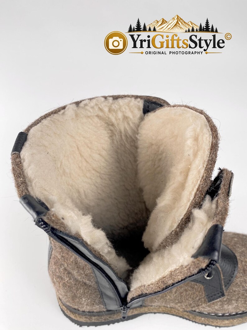 May include: A brown felt boot with a thick, cream-colored wool lining. The boot features a black zipper closure along the side, black trim detailing, and a textured exterior surface. The interior is fully lined with soft, light-colored wool.