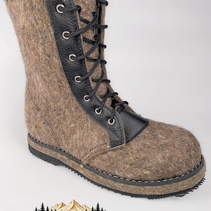 May include: A mid-calf boot crafted from brown felted wool with a black textured leather lace-up panel. The boot features black laces threaded through silver-toned metal eyelets, a rounded toe, and a thick black rubber sole with visible stitching.