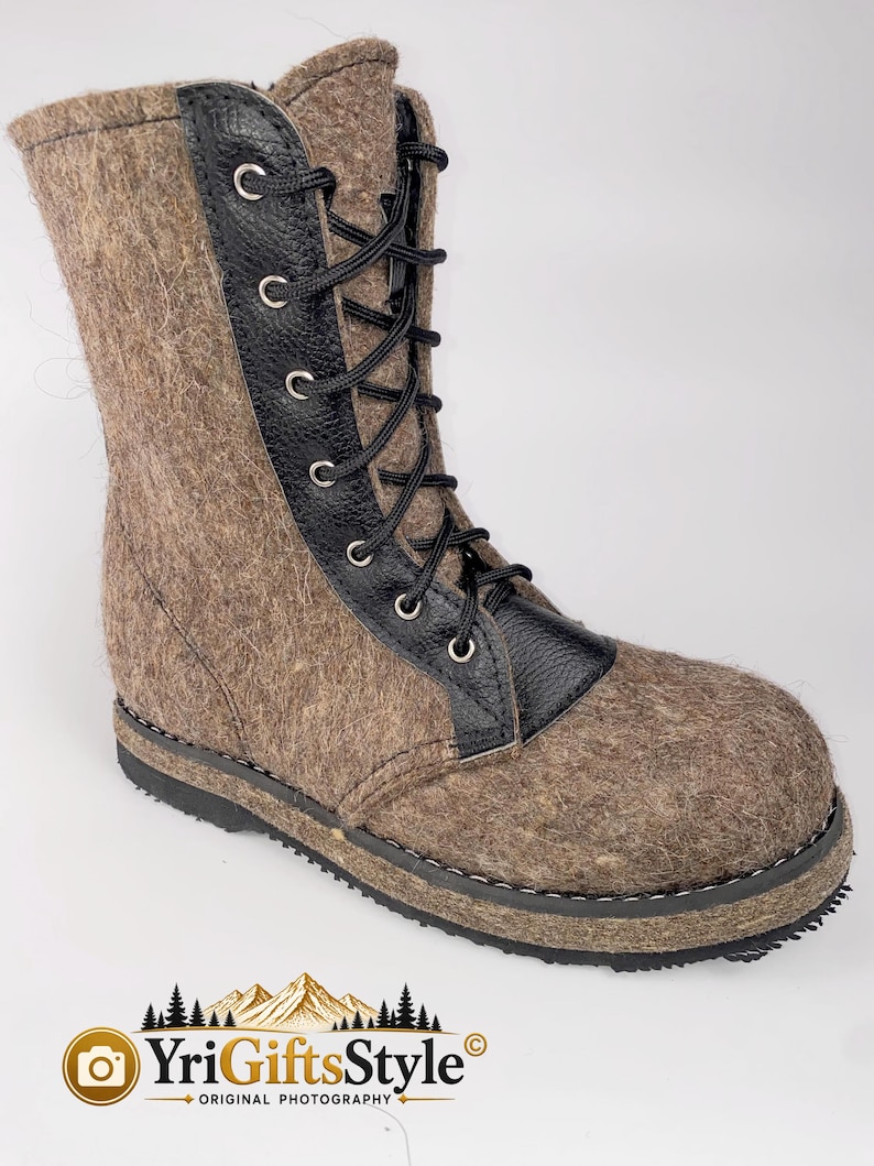 May include: A mid-calf boot crafted from brown felted wool with a black textured leather lace-up panel. The boot features black laces threaded through silver-toned metal eyelets, a rounded toe, and a thick black rubber sole with visible stitching.