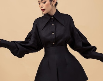 Camisa de lino impactante con cuello amplio y mangas abullonadas: una blusa de alta costura para un guardarropa moderno y lujoso.