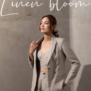 May include: A woman wearing a light grey linen blazer, matching linen shorts, and a linen crop top. The text "linen bloom" is written in white script at the top of the image.