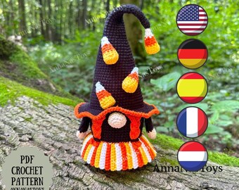 May include: Crochet pattern for a Halloween gnome wearing a black witch hat with candy corn accents and a striped orange, white, and yellow skirt. The pattern is available in multiple languages.