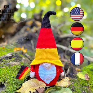 May include: Crochet pattern for a gnome wearing a hat with the colors of the German flag. The gnome is holding a small German flag. The image also includes flags of the United States, Germany, Spain, and France.