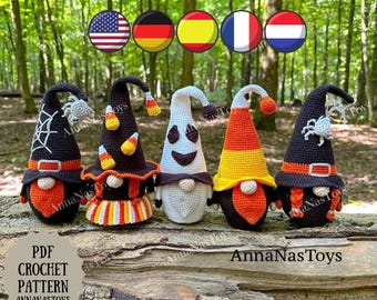 May include: Five handmade crochet Halloween gnomes with various designs. The gnomes have black hats with spiderwebs and spiders, candy corn, and ghost designs. The gnomes are on a wooden surface with the text "AnnaNasToys" and "PDF Crochet Pattern".