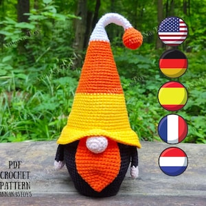 May include: Crochet pattern for a candy corn gnome. The gnome is wearing a white, orange, and yellow hat and has a black beard. The pattern is available in PDF format. The image also includes flags of the United States, Germany, Spain, France, and the Netherlands.