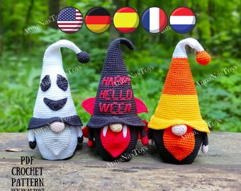 May include: Three crocheted Halloween gnomes. The gnome on the left is a ghost with a white hat and a white body. The gnome in the middle is a vampire with a black hat that says "Happy Halloween" and a red body. The gnome on the right is a candy corn gnome with a yellow and orange hat and an orange body.