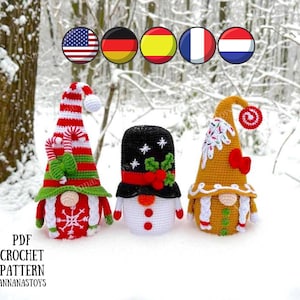 May include: Three crocheted Christmas gnomes, one with a red and white hat, one with a black and white hat, and one with a brown hat. The gnomes are standing on a snowy surface.  PDF CROCHET PATTERN ANNANASTOYS