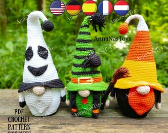 May include: Three crocheted Halloween gnomes. The gnome on the left is white with a ghost face and black hat. The gnome in the middle is green with a black and green striped witch hat and a black spider on top. The gnome on the right is orange and yellow with a candy corn hat.  PDF CROCHET PATTERN ANNANASTOYS