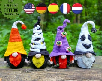 May include: Four crocheted Halloween gnomes with different hats. The gnomes are wearing a candy corn hat, a witch hat with white bandages, a purple hat with candy eyeballs, and a white ghost hat.