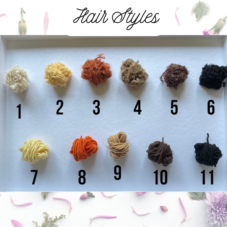 May include: A display of eleven small, textured yarn samples in various colors, arranged in two rows. The samples are numbered and labeled "Hair Styles" in cursive script. Colors include blonde, brown, orange, and black.